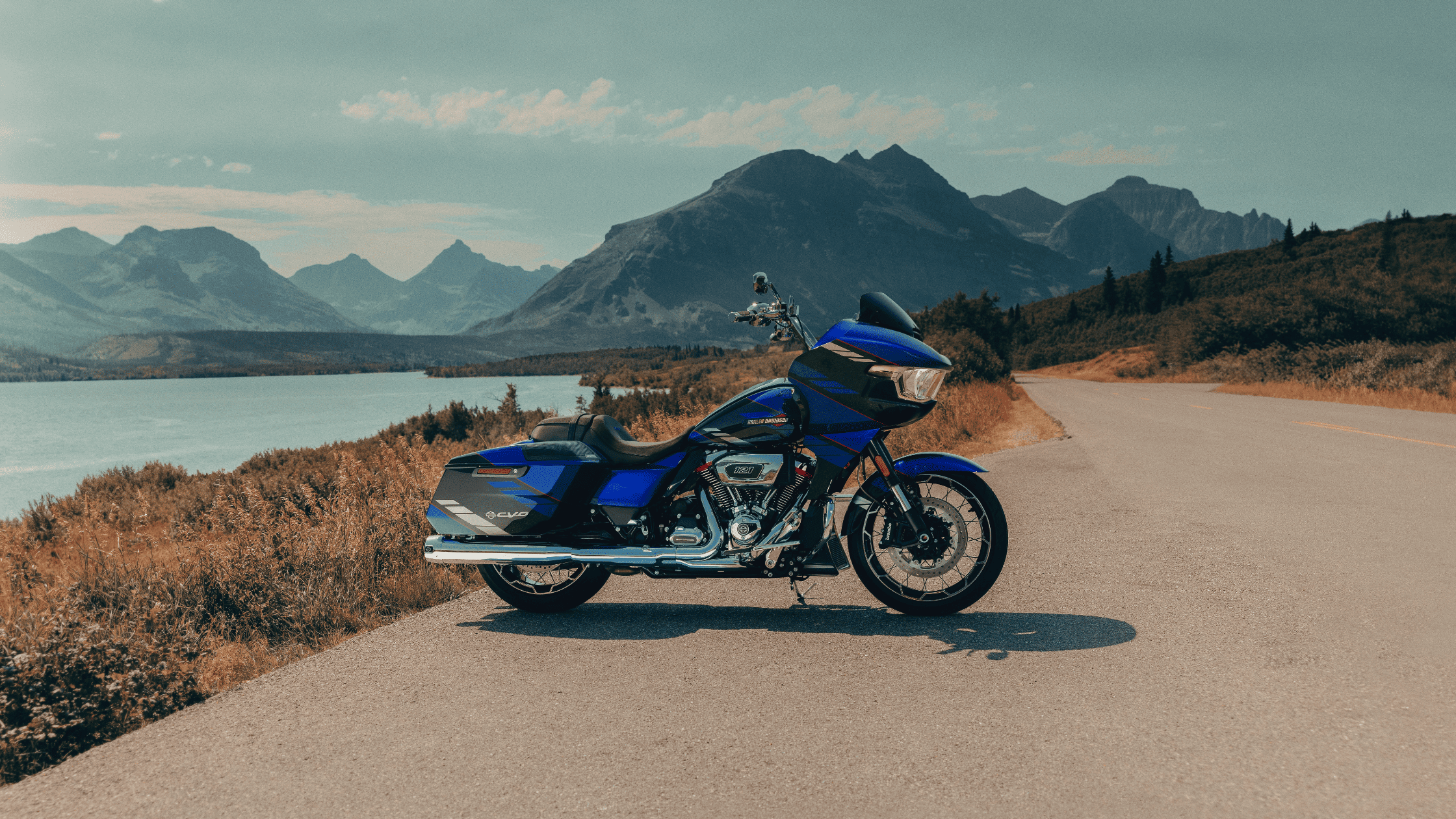 Scenic view of 2025 Harley-Davidson CVO Road Glide beside water and mountain backdrop