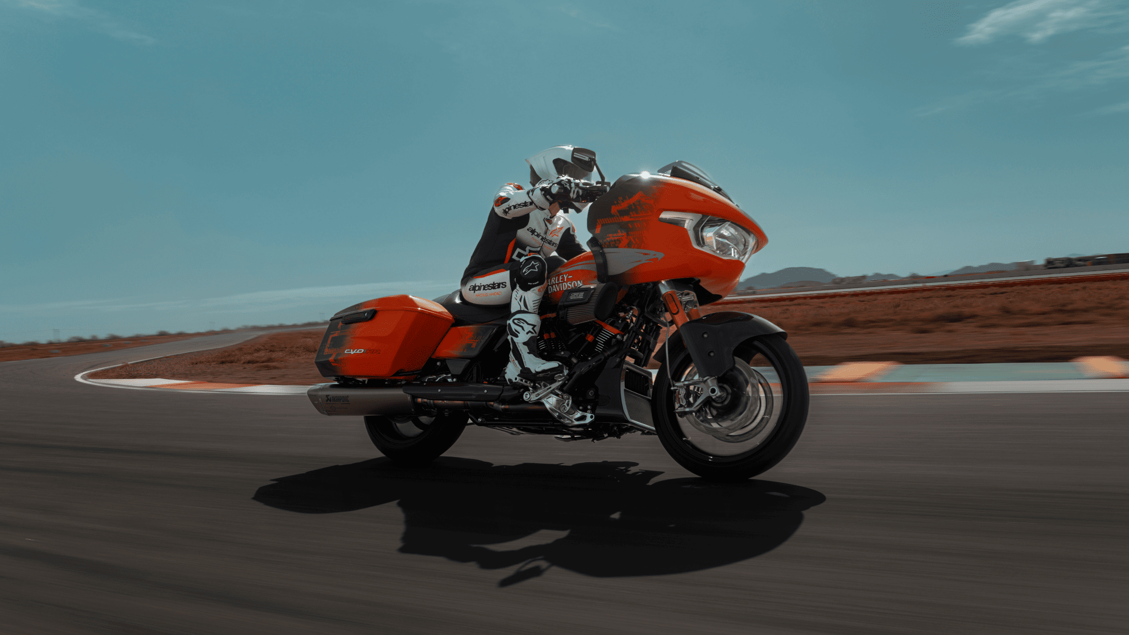The 2025 Harley-Davidson CVO Road Glide RR in striking orange and black, featuring a performance bagger design, aerodynamic fairing, and premium components.